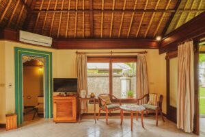 "Outdoor-inspired bathroom with stone walls and potted tropical plants."