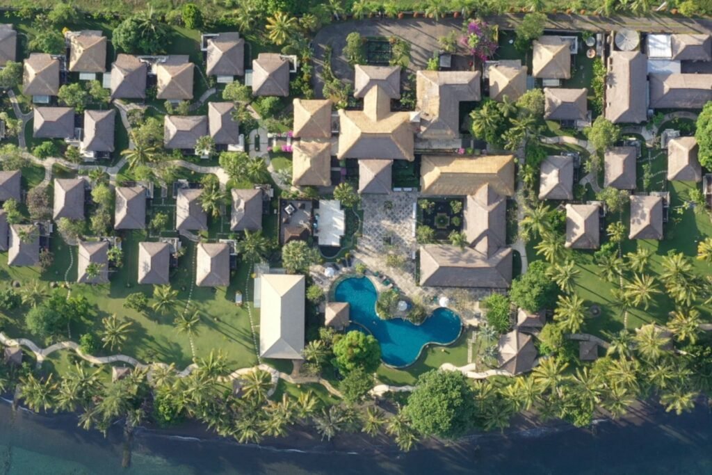 Aerial view of private pool villas surrounded by lush tropical gardens at Puri Bagus Lovina
