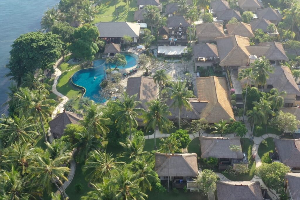 Tropical resort view with blue lagoon-style pool and garden pathways at Puri Bagus Lovina