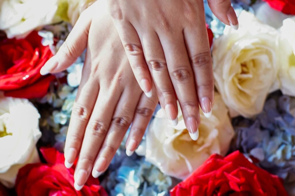 Traditional Balinese wedding henna on bride’s hands with floral background