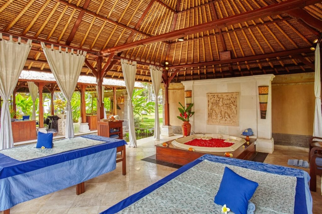Resort spa or massage area with a comfortable bed, traditional wooden roof, and serene decor
